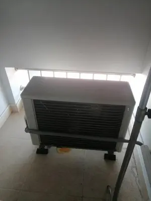 a air conditioner sitting on a floor in a room at KS RESIDENCE Victory Monument in Bangkok