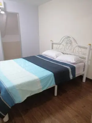 a bedroom with a white bed with a blue blanket at KS RESIDENCE Victory Monument in Bangkok