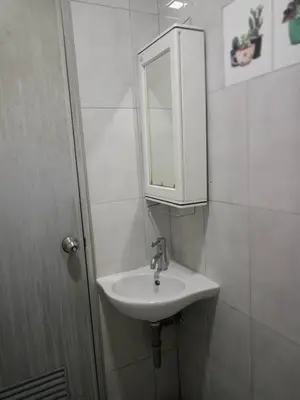 a bathroom with a sink and a medicine cabinet at KS RESIDENCE Victory Monument in Bangkok