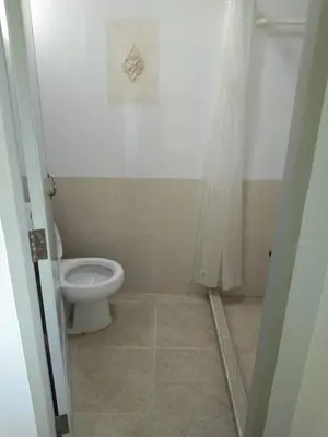 a bathroom with a toilet and a shower stall at KS RESIDENCE Victory Monument in Bangkok