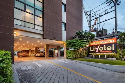 a building with a parking lot in front of it at Livotel Hotel Kaset Nawamin Bangkok in Bangkok