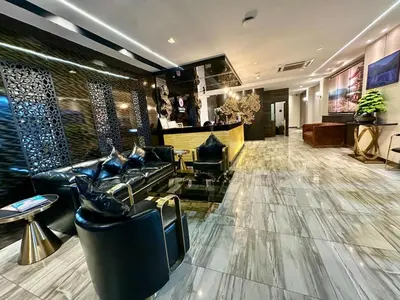 a lobby of a hotel with couches and a bar at Sakura Sky Residence in Bangkok