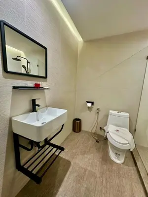 a bathroom with a sink and a toilet at Sakura Sky Residence in Bangkok