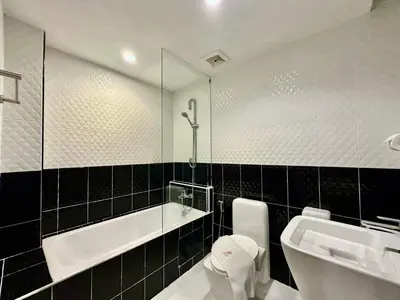 a bathroom with a sink and a toilet and a mirror at Sakura Sky Residence in Bangkok