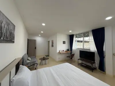 a bedroom with a bed and a living room at Sukhumvit 48 separated room quiet and comfortable with fast internet and smart TV in Bangkok