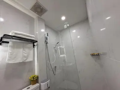 a bathroom with a shower with a glass door at Sukhumvit 48 separated room quiet and comfortable with fast internet and smart TV in Bangkok