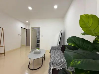 a living room with a couch and a table at Sukhumvit 48 separated room quiet and comfortable with fast internet and smart TV in Bangkok