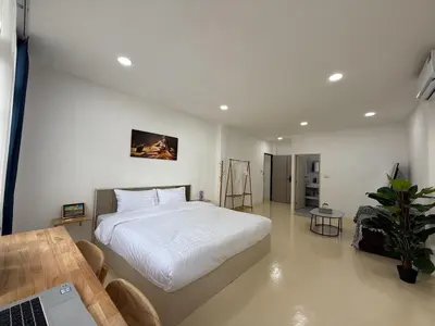 a bedroom with a bed and a table and a laptop at Sukhumvit 48 separated room quiet and comfortable with fast internet and smart TV in Bangkok