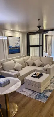 a living room with a couch and a table at Your Urban Oasis in the Heart of Sukhumvit in Bangkok