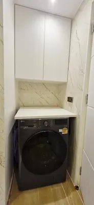 a kitchen with a black dishwasher under a white cabinet at Your Urban Oasis in the Heart of Sukhumvit in Bangkok