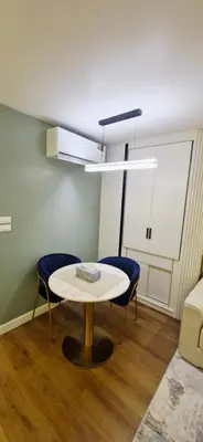 a room with a table and two blue chairs at Your Urban Oasis in the Heart of Sukhumvit in Bangkok