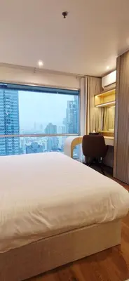 a bedroom with a bed and a large window at Your Urban Oasis in the Heart of Sukhumvit in Bangkok