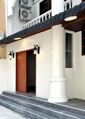 a front door of a white building with stairs at House in the heart of Thonglor, Bangkok, 8 min to BTS in Bangkok