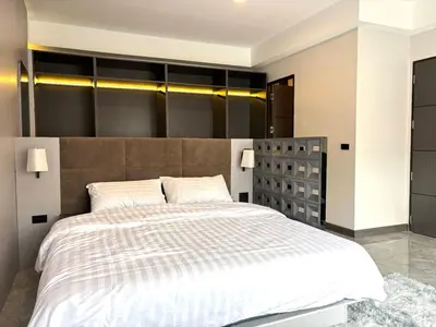 a bedroom with a large bed with a large headboard at House in the heart of Thonglor, Bangkok, 8 min to BTS in Bangkok