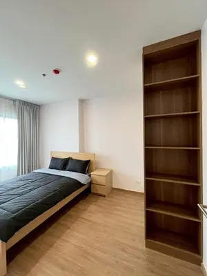 a bedroom with a bed and a book shelf at Stay in near International airport in Bangkok