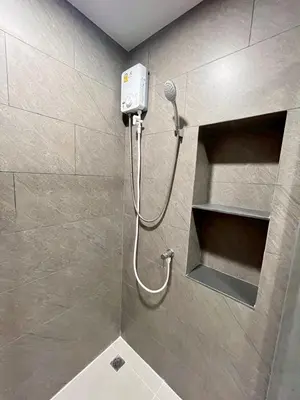 a shower with a shower head in a bathroom at Stay in near International airport in Bangkok