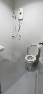 a white bathroom with a toilet and a sink at XX GO INN Khaosan โก อินน์ ตรอกข้าวสาร in Bang Bua Thong Railway Station