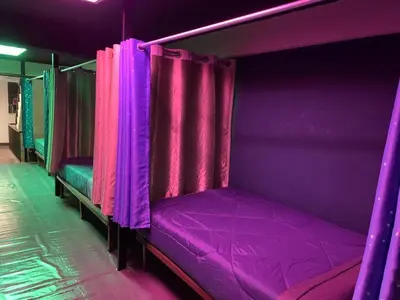 a purple bed with purple curtains in a room at RoXx Social Hostel in Bangkok