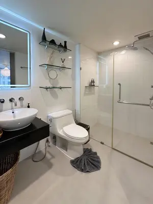 a bathroom with a toilet and a sink and a shower at Prime Classic 1 BR BTS Chidlom 72SQM Langsuan in Bangkok
