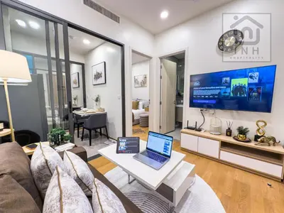 a living room with a couch and a laptop on a table at \u66b9\u7f57\u767e\u4e3d\u5bab\u5962\u534e\u516c\u5bd3 Siam Paragon Luxury Stay #W08 in Pratunam