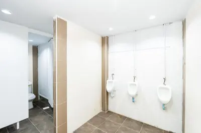 a bathroom with two urinals on the wall at xx The Hidden Khaosan - Rambuttri เดอะ ฮิดเด้น ตรอกข้าวสาร รามบุตรี in Bang Bua Thong Railway Station