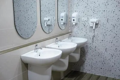 a bathroom with three sinks and mirrors on the wall at CozyTwin Bed วิวระเบียง เจริญนคร in Bangkok