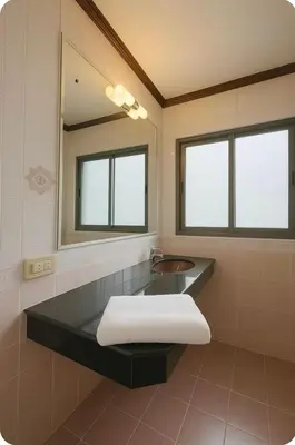 a bathroom with a sink and a mirror at Omalaya Bangkok in Samphanthawong