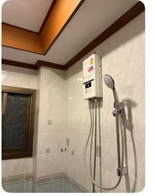 a shower in a bathroom with a shower head at Omalaya Bangkok in Samphanthawong