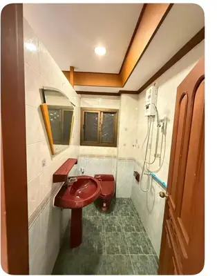 a bathroom with a red sink and a toilet at Omalaya Bangkok in Samphanthawong