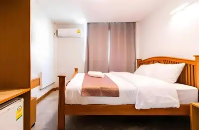 a bedroom with a bed with white sheets at GO INN Khaosan Chakraphong โก อิน ตรอกข้าวสาร Pro in Bang Bua Thong Railway Station