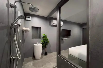 a bathroom with a shower with a toilet and a sink at HK Villa Resort in Bangkok