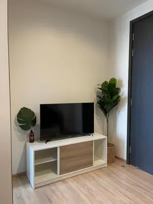 a flat screen tv sitting on a white entertainment center at Private in Bangkapi in Bangkok