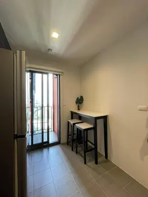 a room with a table and two stools and a balcony at Private in Bangkapi in Bangkok
