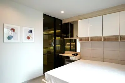 a bedroom with a bed and a desk at 2 Bedroom Life Ladprao in Bangkok