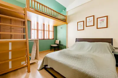 a bedroom with a bunk bed and a ladder at TermSuk Apt- Banthat Thong in Bangkok