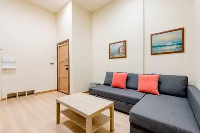 a living room with a couch and a table at TermSuk Apt- Banthat Thong in Bangkok