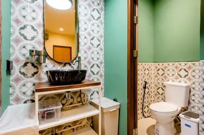 a bathroom with a sink and a mirror at TermSuk Apt- Banthat Thong in Bangkok