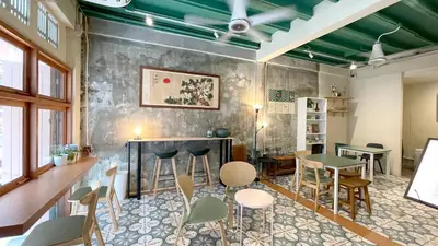 a room with a bar with chairs and tables at TermSuk Apt- Banthat Thong in Bangkok