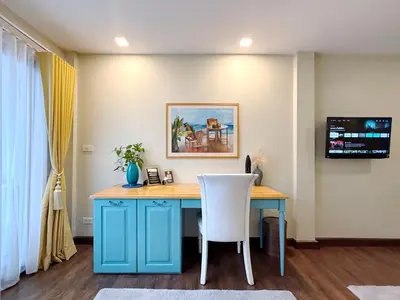 a blue desk with a white chair in a room at Urban Charm & Unique at KIT-TI's Art Home Sukhumvit in Bangkok