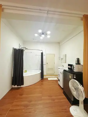 a bathroom with a tub and a kitchen with a sink at Spacious, just an 850m walk to MRT Rama 9 station in Bangkok