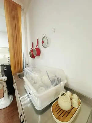 a kitchen counter with a bowl and dishes in it at Spacious, just an 850m walk to MRT Rama 9 station in Bangkok