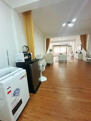 a large room with a kitchen and a living room at Spacious, just an 850m walk to MRT Rama 9 station in Bangkok