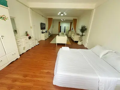 a bedroom with a large white bed in a room at Spacious, just an 850m walk to MRT Rama 9 station in Bangkok