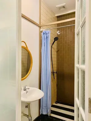 a bathroom with a sink and a shower at Loft Rattanakosin Mansion in Bangkok