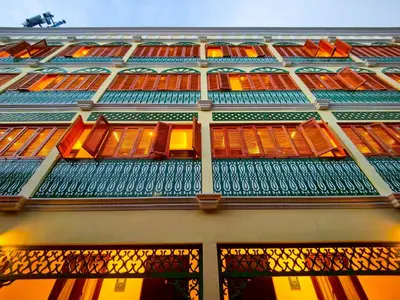 a building with orange and green windows and a balcony at Bangluang Boutique Hotel in Bangkok