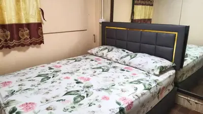 a bedroom with a bed with a floral bedspread at Rhythm of love in Bangkok