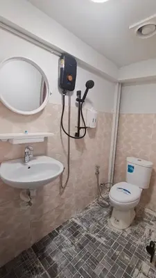 a bathroom with a sink and a mirror and a toilet at Rhythm of love in Bangkok