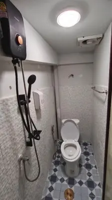 a bathroom with a toilet and a camera in it at Rhythm of love in Bangkok