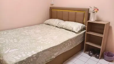 a bedroom with a bed with a flower vase on it at Rhythm of love in Bangkok