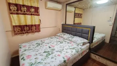 a small bedroom with a bed and a mirror at Rhythm of love in Bangkok